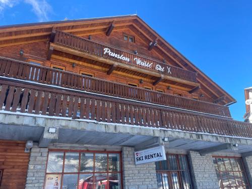 a wooden building with a sign on top of it at Pansion Vlašić Ski in Šišava