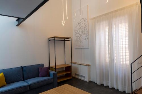 a living room with a blue couch and a table at La Dimora dei Paladini in Bagheria