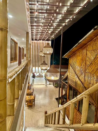 a lobby of a building with chairs and chandeliers at La Posada de Mindo in Mindo