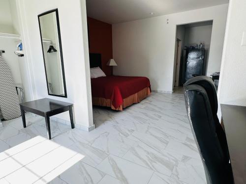 a hotel room with a bed and a mirror at Lux Inn and Suites in Three Rivers