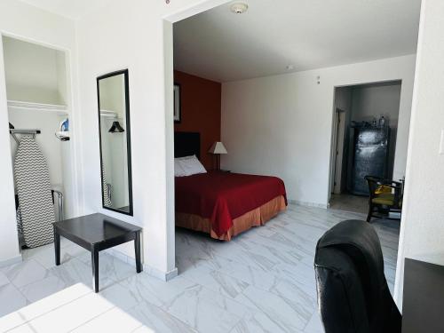 a hotel room with a bed and a mirror at Lux Inn and Suites in Three Rivers