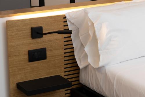 a bed in a room with a wooden wall with at La Dimora dei Paladini in Bagheria