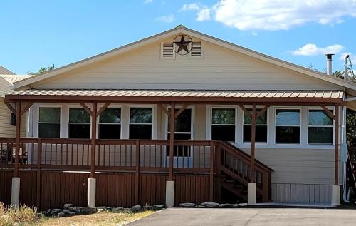 a house with a porch with a deck at Classic Charm Close To Lake in Canyon Lake