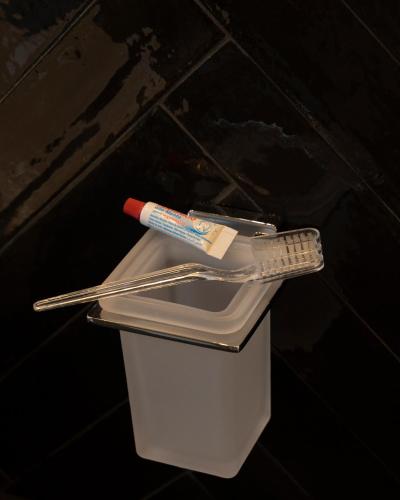 a toothbrush and a remote control in a trash can at La Dimora dei Paladini in Bagheria