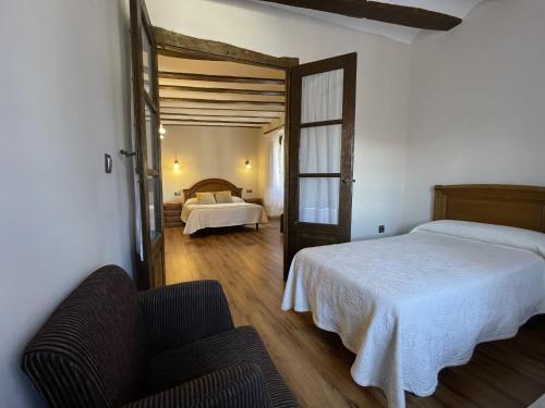 a bedroom with two beds and a couch in it at CASA RURAL HORMILLA in Hormilla