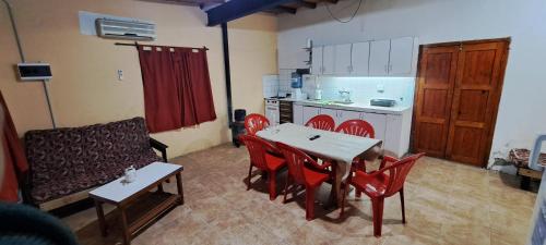 a living room with a table and chairs and a kitchen at Hospedaje Catalina in Belén