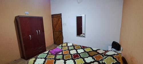 a bedroom with a bed and a dresser at Hospedaje Catalina in Belén