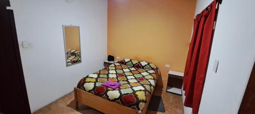 a small bedroom with a bed in a room at Hospedaje Catalina in Belén