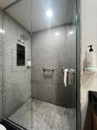 a shower with a glass door in a bathroom at Hampton by Hilton Aguascalientes Downtown in Aguascalientes
