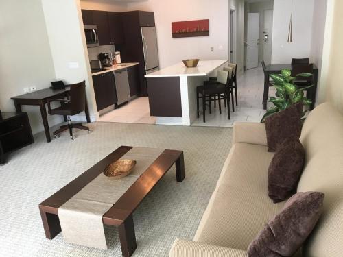 a living room with a couch and a table at Doral 2-Story Villa 3 Bed 4 Bath at Provident Doral at The Blue Miami in Miami