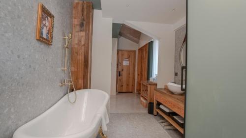 a bathroom with a tub and a sink at Patio Spring Holiday Inn -- Free round trip pick-up service --Panoramic view of Tianmen Mount in Zhangjiajie