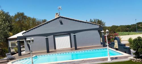 une maison avec une piscine devant dans l'établissement la Recouturière, à Saint-Thibéry