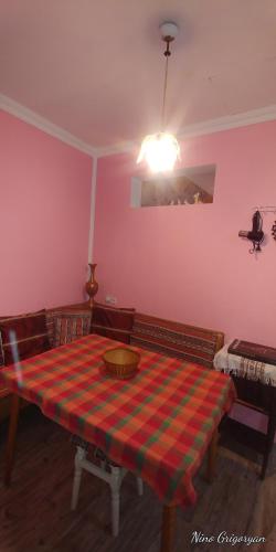 a room with a table with a plaid table cloth at Guest House Nise in Tbilisi City