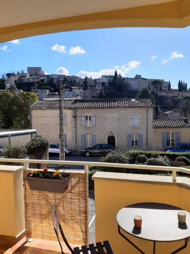 - un balcon avec une table et des chaises dans l'établissement Le Cèdre, appartement avec garage, à Vaison-la-Romaine