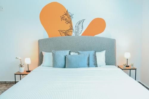 a bedroom with a large bed with blue pillows at Casa de Playa Hatillo in Hatillo