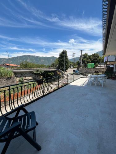 a bench on a patio with mountains in the background at La casa di fufy in Serino