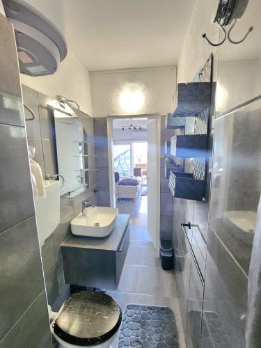 a bathroom with a sink and a toilet at Apartment Vanessa in Krk