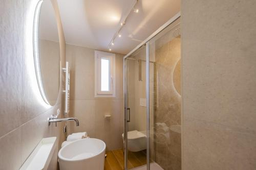 a bathroom with a shower and a toilet and a sink at La Nuvola in Chieti