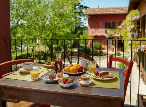 a table with breakfast food on a balcony at Cascina Sant'Eufemia in Sinio