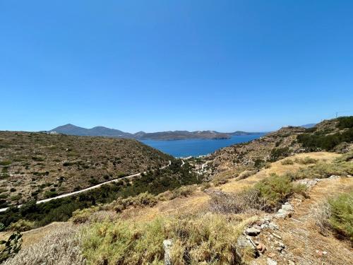 a view of a lake from a hillside at Lukianos House in Tripití