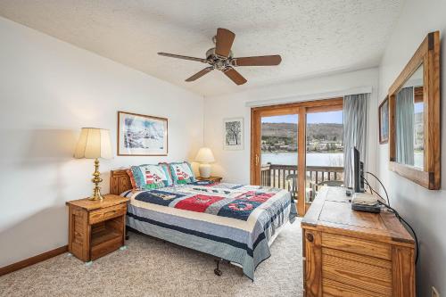 a bedroom with a bed and a ceiling fan at Ski Harbor 16 in McHenry