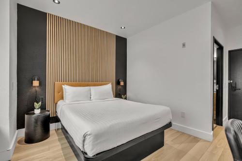 a bedroom with a large bed with white sheets at The Block Hotel in Bentonville