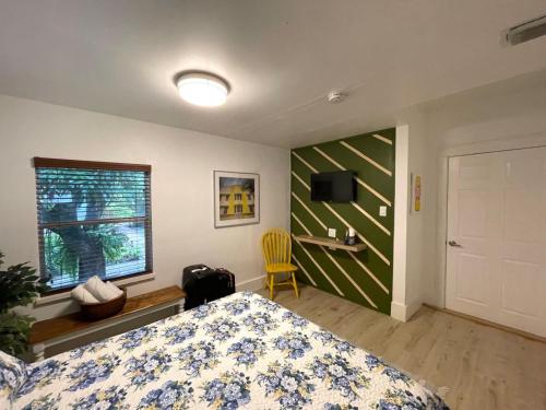 a bedroom with a bed and a television and a window at Cozy Room in the Heart of Little Havana in Miami