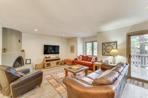 a living room with leather furniture and a fireplace at Half Mi to Angel Fire Resort Townhome with Grill! in Angel Fire