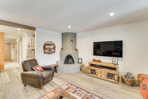 a living room with a fireplace and a tv at Half Mi to Angel Fire Resort Townhome with Grill! in Angel Fire