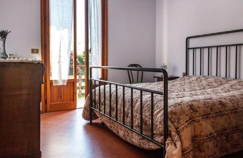 a bedroom with a bed and a large window at podere la casellina in Figline Valdarno