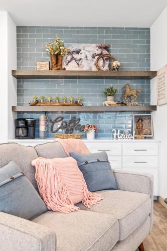 a couch in a living room with a blue wall at Arlington Retreat in Arlington