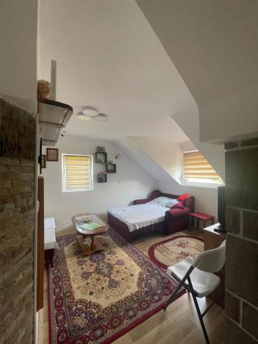 a living room with a bed and a couch at Vila Zvezdane večeri in Rudnik Kačerski