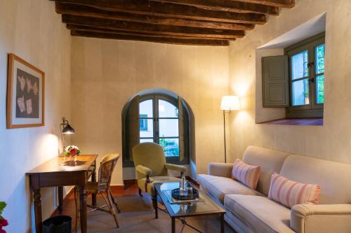 a living room with a couch and a table at Hotel Boutique Molino del Arco in Ronda