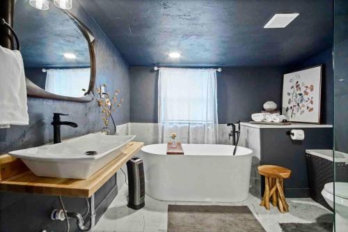 a bathroom with a large tub and a sink at Uptown Studio Soaking Tub & Private Yard #04 in Oklahoma City