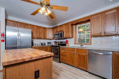 a kitchen with wooden cabinets and a ceiling fan at Serenity Chalet in Oakland