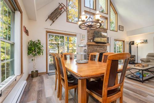 a dining room with a wooden table and chairs at Serenity Chalet in Oakland