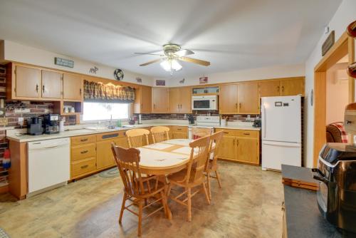 a kitchen with a table and chairs and a refrigerator at Cozy Home with ATV Trail Access in Berlin! in Gorham