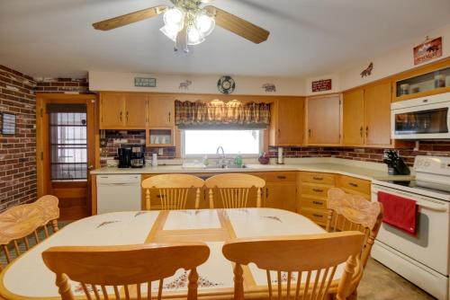 a kitchen with a table and chairs in it at Cozy Home with ATV Trail Access in Berlin! in Gorham