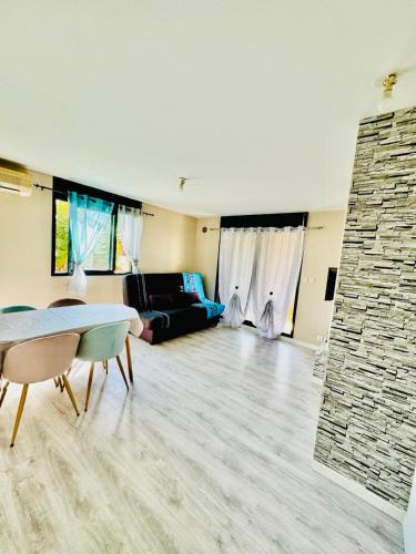 a living room with a couch and a table at Le Chalet in Le Tampon