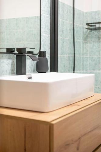 a white bathroom sink sitting on top of a wooden counter at Ferienwohnung Bergzeit in Pfronten