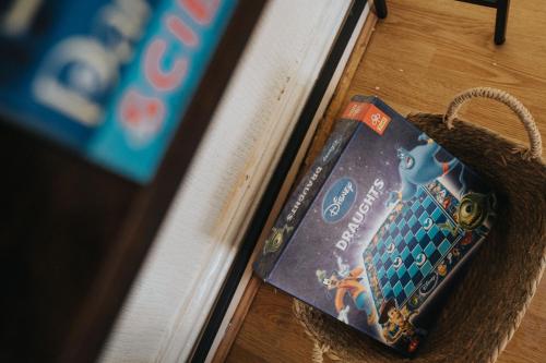 a book sitting on the floor next to a table at Entire 5 Bedroom home in Birkenhead-Free Parking, Group & Family-Friendly, Free Internet in Birkenhead