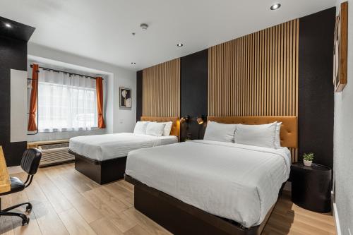 a hotel room with two beds and a desk at The Block Hotel in Bentonville