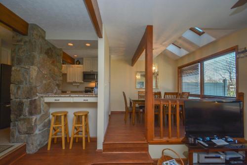 a kitchen and dining room with a stone wall at Ski Harbor 07 in McHenry