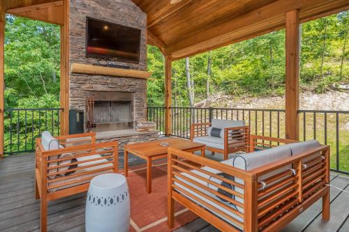 a screened porch with benches and a fireplace at Parhelion Chalet in McHenry
