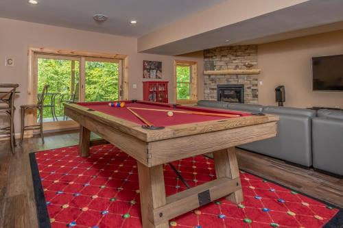 a living room with a pool table and a couch at Parhelion Chalet in McHenry