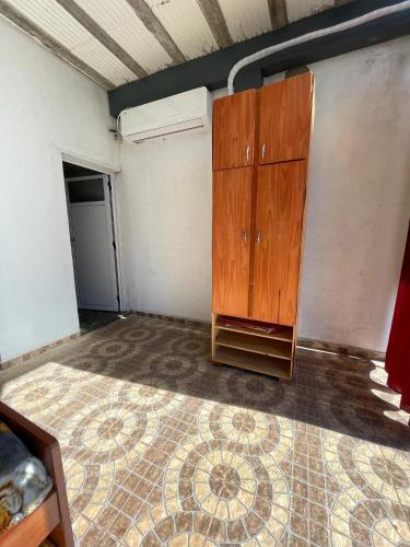 a room with a wooden cabinet and a tiled floor at Alojamiento Itaembe Guazu in Villa Dolores