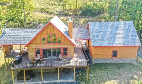 an aerial view of a log home with a deck at Parhelion Chalet in McHenry