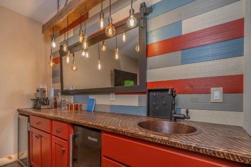 a kitchen with a sink and a mirror at Parhelion Chalet in McHenry