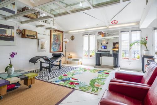 un salon avec un canapé rouge et une table dans l'établissement Loft central, à Paris