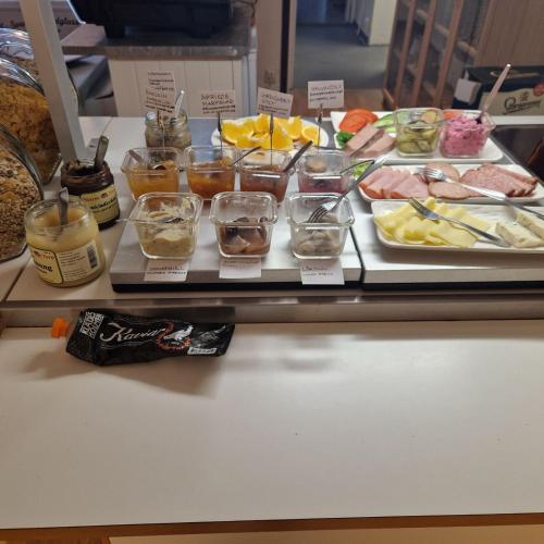 a buffet with different types of food on a table at Tostarps Pensionat in Hässleholm